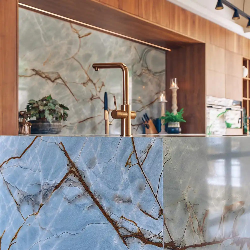 Marble counter in Kitchen with gold tap and marble backsplash